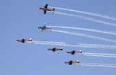 RAAF stunt planes flying in formation trailing smoke