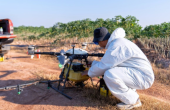 A farmer inspecting an aerial spraying drone