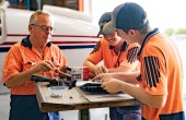 a group of aircraft maintenance engineers discussing 