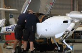 Two maintenance engineers examining the inside of an aeroplane