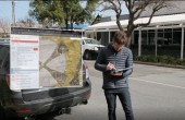 A drone pilot consulting a map of airspace on his tablet