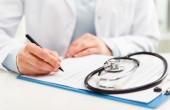 Close up image of a doctor writing