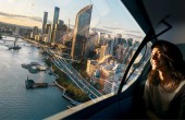 A woman riding in an AAM flying over the Brisbane CBD