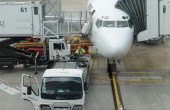 A passenger jet being prepared at an airport terminal