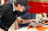A young maintenance engineer examines an aircraft component