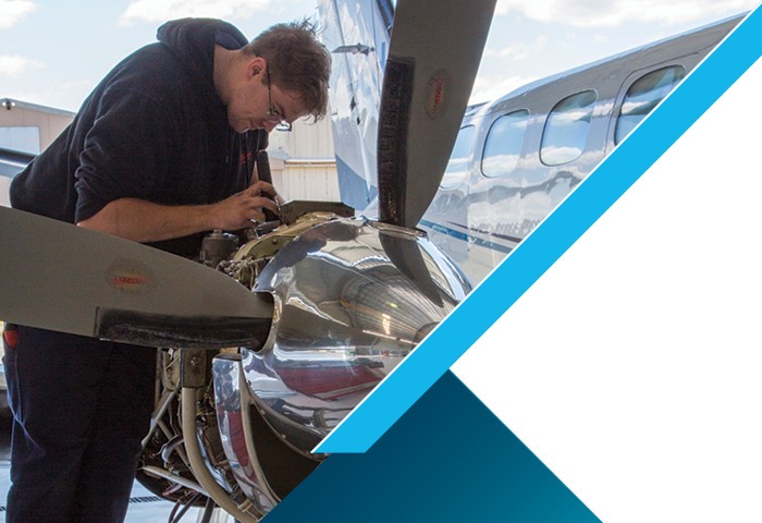 Person working on plane engine