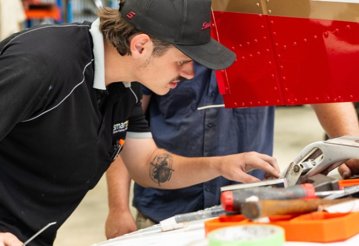A young maintenance engineer examines an aircraft component