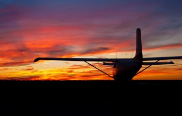 An aeroplane silhouetted against the sunset