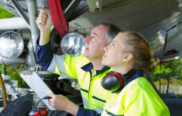 Two maintenance engineers inspecting an aircraft's landing gear