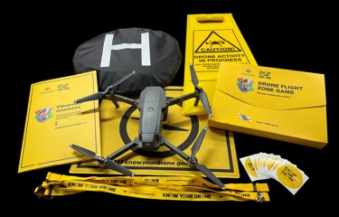 A collection of Know Your Drone resources with a DJI Mavic drone sitting on top of them