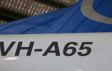 The tail of a plane, with registration 'VH-A65' printed on it
