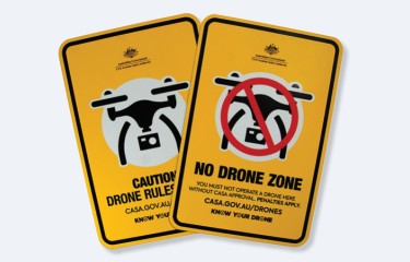 The two metal Know Your Drone safety signs sitting partly overlapping each other on a white background