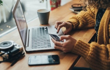 A woman shopping online using her laptop