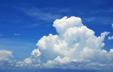 A fluffy cloud in a blue sky