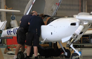 Two maintenance engineers examining the inside of an aeroplane