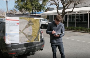 A drone pilot consulting a map of airspace on his tablet