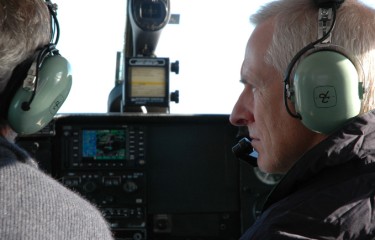 A pilot of an aircraft looking at the pilot on his left