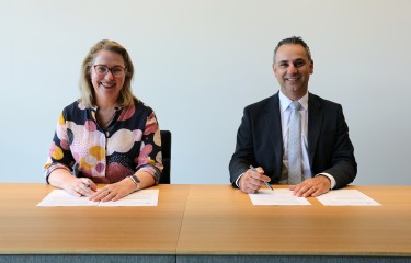 Pip Spence, CASA CEO and Director of Aviation Safety, and Enrico Palermo, Head of the Australian Space Agency, smile as they sign the Memorandum of Understanding