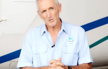 An airline managing director being interviewed in front of a plane