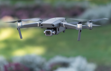 A quadcopter drone flying through the air.