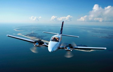 A Beechcraft twin-engine aeroplane flying through the sky