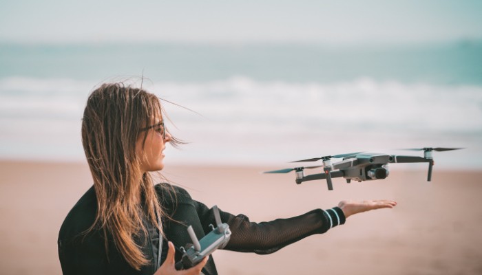 Image of a lady releasing a drone