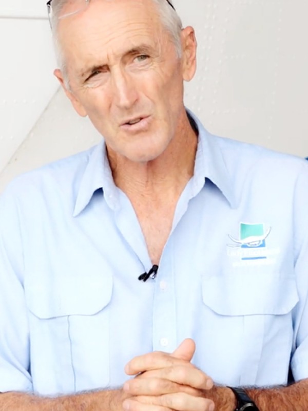 An aviation expert being interviewed in front of an aeroplane