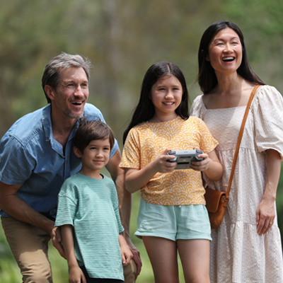 Family flying a drone together.